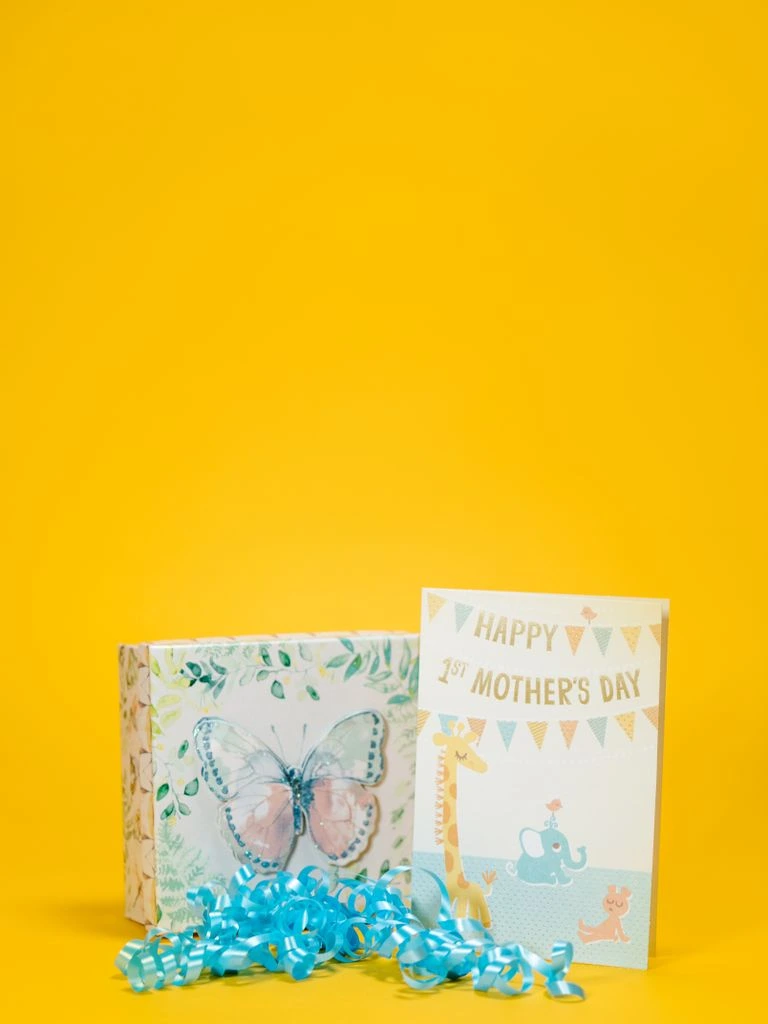 New baby card with a bear wrapped in a knitted blanket